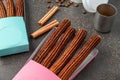 Top view of take away coffee next to chocolate filled and plain churros Royalty Free Stock Photo