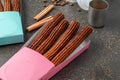 Top view of take away coffee next to chocolate filled and plain churros Royalty Free Stock Photo