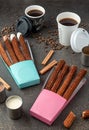 Top view of take away coffee next to chocolate filled and plain churros Royalty Free Stock Photo