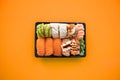 Top view of take away sushi package on coloful background