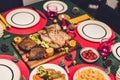 Top view of tasty baked roasted whole fried chicken and salad with christmas decoration on the christmas themed dinner table Royalty Free Stock Photo