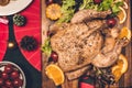 Top view of tasty baked roasted whole fried chicken and salad with christmas decoration on the christmas themed dinner table Royalty Free Stock Photo