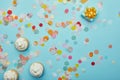 Top view of tasty cupcakes, confetti and gift Royalty Free Stock Photo