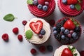 top view tasty cupcakes with cream, strawberries, raspberries and blueberries flatlay on a light concrete background