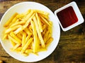 Top view of tasty french fries or potato fries with ketchup on wooden table Royalty Free Stock Photo