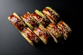 top view of tasty green dragon sushi rolls with salmon, avocado, cucumber and green caviar poured with teriyaki sauce. Royalty Free Stock Photo