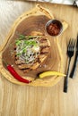 Top view tasty Grilled Pork neck served on pita bread with onion, microgreen and hot pepper. Wooden background. Copy space. Royalty Free Stock Photo