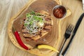 Top view tasty Grilled Pork neck served on pita bread with onion, microgreen and hot pepper. Wooden background. Copy space. Royalty Free Stock Photo