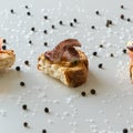 Top view of tasty Italian appetizers -  bruschetta with raw tomatoes and octopus tentacles, on slices of toasted baguette Royalty Free Stock Photo