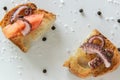 Top view of tasty Italian appetizers -  bruschetta with raw tomatoes and octopus tentacles, on slices of toasted baguette Royalty Free Stock Photo