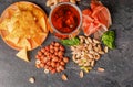 Top view of tasty snacks and dark beer on a table background. Peanuts, pistachios, prosciutto with a glass of beer. Cold Royalty Free Stock Photo