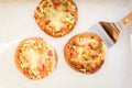 Top view of tasty three Pizzetta on white background