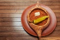 Top view on tasty traditional Adjarian Khachapuri - open baked pie with meat and pepperyolk on wooden tray. Traditional