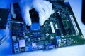 Top view of technician installing CPU onto motherboard
