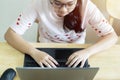 Top view of teen girl with laptop in her room while sitting at the desk and writing on her laptop Royalty Free Stock Photo