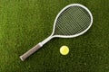 Top view of tennis racket and ball on green grass Royalty Free Stock Photo