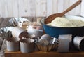 Top view.Test for Easter cakes, croissants, rolls on the background of molds for Easter cakes and ingredients for kneading dough