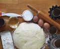 Top view.Test for Easter cakes, croissants, rolls on the background of molds for Easter cakes and ingredients for kneading dough