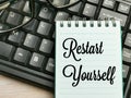 Top view text Restart Yourself written on note book