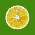 Top view of textured ripe lemon citrus slice isolated on green background Royalty Free Stock Photo