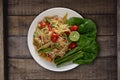 Top view Thai food rice noodle papaya salad on wooden table