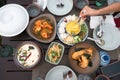 Top view of Thai food with salted crab, rice noodles, fried sea bass, sliced mango spicy, creamy chicken soup, vermicelli salad Royalty Free Stock Photo