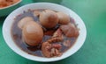 A top view of Thai food, stewed eggs, stewed pork legs, herbs in a bowl, placed on the table.