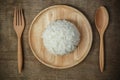 Top view of Thai jasmine rice in wooden dish with napery and wooden spoon - soft focus