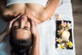 Top view of Thai oil Ayurvedic face massage with aroma candle in spa Royalty Free Stock Photo