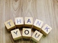 Thank you word wooden block on wooden background