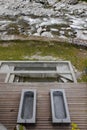 Top view of the thermal baths on a wooden platform overlooking the river and Swiss nature