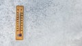 Top view on thermometer laying on layer of ice, showing temperature as low as -20 degrees Celsius. Concept illustrating extreme c