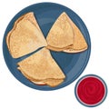 Top view of thin pancakes folded in triangles in blue plate and bowl with berry jam isolated on white background.