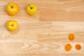 Top view of three apples and dried apricots with copyspace on a wooden table Royalty Free Stock Photo