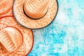 Top view of three beach straw hats from above