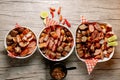 Top view of three bowls of different sliced meats and a bowl of vegetable soup on the side Royalty Free Stock Photo