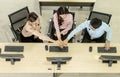 Top view of three business call center people in formal wear standing and discussing and shake hands and folding their hands on h Royalty Free Stock Photo