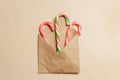 Top view three candy canes in brown envelope on brown color wood background Royalty Free Stock Photo