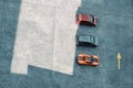 Top view of three cars parked in a driving area