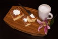 Top view of three Churro Cheesecake pieces and a drink on a wooden base Royalty Free Stock Photo