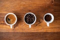 Top view of three different varieties of coffee on wooden background Royalty Free Stock Photo