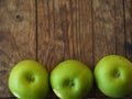 Top view of Three green apples on wooden background Royalty Free Stock Photo
