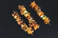 Top view from three grilled shaslik skewers served on a slate wi Royalty Free Stock Photo