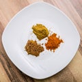 Top view of three indian curry spices, orange , yellow and brown Royalty Free Stock Photo