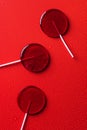 top view of three lollipops on red surface Royalty Free Stock Photo