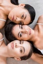 top view of three multicultural attractive women laying