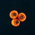 Top view of three persimmons