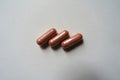Top view of 3 pink capsules of PQQ dietary supplement Royalty Free Stock Photo
