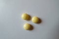 Top view of 3 round yellow pills of xylitol