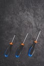 top view of three screwdrivers placed in row on black